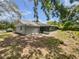 Backyard view featuring a screened-in porch and a spacious yard area at 1122 Romar Ln, Apopka, FL 32712