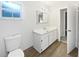 Bathroom features a spacious vanity, a large mirror, and ample storage, paired with wood-look flooring at 1122 Romar Ln, Apopka, FL 32712