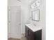 An updated bathroom with a modern vanity, framed mirror, and stylish lighting fixtures above the sink at 1122 Romar Ln, Apopka, FL 32712