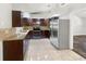 Modern kitchen featuring stainless steel appliances, granite countertops, and ample cabinet space at 1122 Romar Ln, Apopka, FL 32712