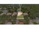An aerial view of a home with a red tile roof surrounded by other residences in a lush community at 11834 Gennaro Ln, Orlando, FL 32827
