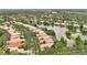 Aerial view of neighborhood with lake views, manicured lawns, and mature trees surrounding beautiful single Gathering homes at 11834 Gennaro Ln, Orlando, FL 32827