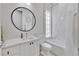 Bright bathroom with a round mirror, floating vanity, and shower/tub combination at 11834 Gennaro Ln, Orlando, FL 32827