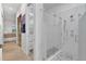 Bathroom featuring glass enclosed shower, closet with vanity and bedroom visible in the background at 11834 Gennaro Ln, Orlando, FL 32827
