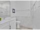 Bright bathroom features marble tiled walls, glass enclosed shower and large vanity with sink at 11834 Gennaro Ln, Orlando, FL 32827