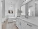Bright white bathroom with soaking tub, vanity, and modern chandelier at 11834 Gennaro Ln, Orlando, FL 32827