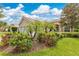 Beautiful single-story home with lush landscaping, flowering bushes, and a three car garage at 11834 Gennaro Ln, Orlando, FL 32827