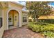 Inviting front entrance with a charming brick walkway and manicured landscaping at 11834 Gennaro Ln, Orlando, FL 32827