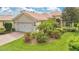 Charming home with a well-maintained lawn, mature landscaping, and a brick driveway at 11834 Gennaro Ln, Orlando, FL 32827