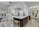 Stylish kitchen featuring granite countertops, an island with seating, and white cabinets at 11834 Gennaro Ln, Orlando, FL 32827