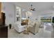 Comfortable living room featuring built-in shelving, neutral furniture, and pool views at 11834 Gennaro Ln, Orlando, FL 32827