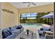 Inviting outdoor living space with comfortable seating, a ceiling fan, and a view of the pool and lake at 11834 Gennaro Ln, Orlando, FL 32827