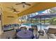 Inviting outdoor space with comfortable seating, a ceiling fan, and a view of the pool and lake at 11834 Gennaro Ln, Orlando, FL 32827