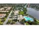Aerial view of community pool, tennis courts, clubhouse and lake surrounded by beautiful landscaping at 11834 Gennaro Ln, Orlando, FL 32827