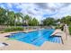 Beautiful community pool with sparkling water, lounge chairs, and lush landscaping at 11834 Gennaro Ln, Orlando, FL 32827