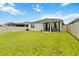 Spacious backyard featuring a covered patio area and lush green lawn at 12084 Sumter Dr, Orlando, FL 32824