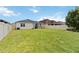 Expansive backyard with a covered patio and privacy fence at 12084 Sumter Dr, Orlando, FL 32824