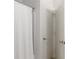 Bathroom with a shower-tub combination with white shower curtain and white doors at 12084 Sumter Dr, Orlando, FL 32824