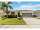 Charming single-Gathering home with a well-manicured lawn, a two-car garage, and tropical landscaping at 12084 Sumter Dr, Orlando, FL 32824