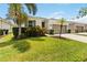 Charming single-Gathering home with a well-manicured lawn, a two-car garage, and tropical landscaping at 12084 Sumter Dr, Orlando, FL 32824