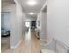 Long hallway with wood-look tile flooring connecting the living spaces at 12084 Sumter Dr, Orlando, FL 32824