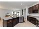 Open concept kitchen with stainless steel appliances, granite countertops and a view into the living room at 12084 Sumter Dr, Orlando, FL 32824