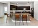 Modern kitchen with dark wood cabinets, granite countertops, and stainless steel appliances with a central island at 12084 Sumter Dr, Orlando, FL 32824
