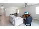 Bright, open-concept living room with light-colored tile flooring, modern decor, and combined dining area at 12084 Sumter Dr, Orlando, FL 32824