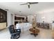 Bright, open-concept living room with light-colored tile flooring, modern decor, and combined dining area at 12084 Sumter Dr, Orlando, FL 32824