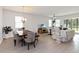 Bright living room with light-colored tile flooring, modern decor, and sliding doors to a lanai at 12084 Sumter Dr, Orlando, FL 32824