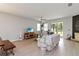 Bright living room with light-colored tile flooring, modern decor, and sliding doors to a lanai at 12084 Sumter Dr, Orlando, FL 32824