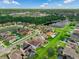 Aerial view showing homes with manicured lawns, a serene lake, and lush greenery in a suburban neighborhood at 1270 Fountain Coin Loop, Orlando, FL 32828