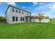 Exterior of a two-story house with a spacious backyard and well-maintained lawn at 1270 Fountain Coin Loop, Orlando, FL 32828