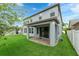 Home exterior featuring a covered patio and a spacious, green backyard at 1270 Fountain Coin Loop, Orlando, FL 32828
