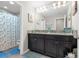 Well-lit bathroom featuring double vanity, granite countertop, and blue-themed decor at 1270 Fountain Coin Loop, Orlando, FL 32828