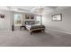 Bright and airy bedroom featuring large windows, tray ceilings, neutral tones, and a chandelier at 1270 Fountain Coin Loop, Orlando, FL 32828