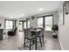 Bright dining area with a dark wood table, four chairs, and access to the living room at 1270 Fountain Coin Loop, Orlando, FL 32828