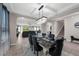 Open-concept dining area with modern lighting and decor that connects to the living room and staircase at 1270 Fountain Coin Loop, Orlando, FL 32828