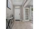 Inviting entryway with a console table, neutral decor, and an arched doorway leading to other rooms at 1270 Fountain Coin Loop, Orlando, FL 32828