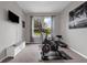 Exercise room featuring an exercise bike, elliptical, wall mounted TV, and bench at 1270 Fountain Coin Loop, Orlando, FL 32828