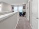 Upstairs hallway featuring carpet and view of the lounge area. Natural light coming from the lounge at 1270 Fountain Coin Loop, Orlando, FL 32828