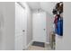 Hallway featuring neutral paint and two doors, one with a dark bronze knob and the other painted white at 1270 Fountain Coin Loop, Orlando, FL 32828