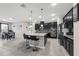 Spacious open kitchen with dark cabinets, granite countertops and adjacent dining area at 1270 Fountain Coin Loop, Orlando, FL 32828