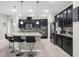 Spacious kitchen featuring an island with granite countertops, dark cabinets, and stainless appliances at 1270 Fountain Coin Loop, Orlando, FL 32828