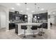 Modern kitchen with a large island, dark cabinetry, granite countertops, and stainless appliances at 1270 Fountain Coin Loop, Orlando, FL 32828
