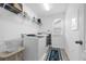 Bright laundry room with modern appliances, wire shelving, and ample space at 1270 Fountain Coin Loop, Orlando, FL 32828