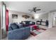 Spacious living room with a ceiling fan, two couches, ottoman, and large windows offering natural light at 1270 Fountain Coin Loop, Orlando, FL 32828