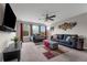 Spacious living room with a ceiling fan, two couches, ottoman, and large windows offering natural light at 1270 Fountain Coin Loop, Orlando, FL 32828