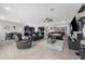 Spacious living room featuring tile flooring, black leather furniture, and an open layout at 1270 Fountain Coin Loop, Orlando, FL 32828