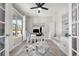 Bright home office with a large window, modern desk setup, and built-in shelving for storage at 1270 Fountain Coin Loop, Orlando, FL 32828